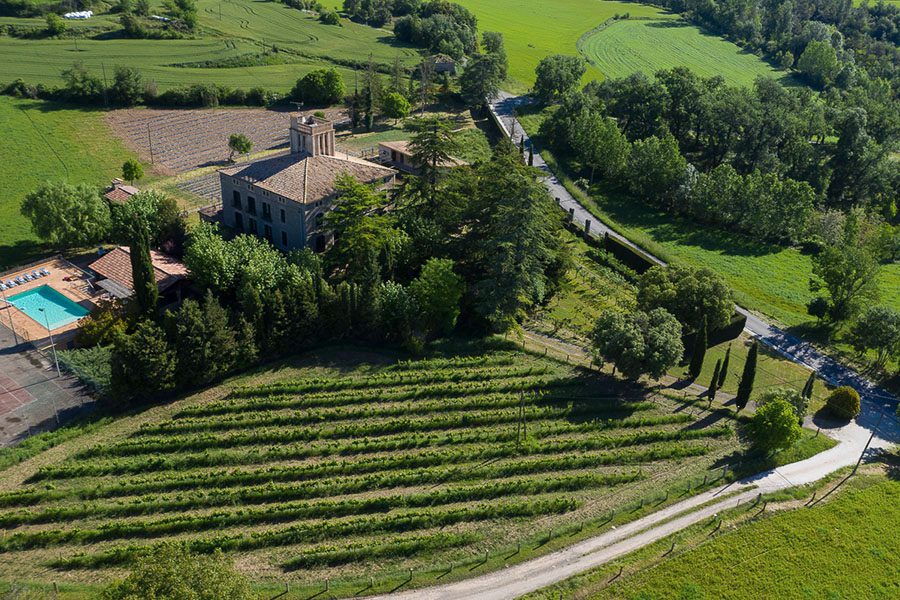 Aerial view of Hot Yoga Academy and its surrounding farmland in Santa Maria de Merles near Barcelona.